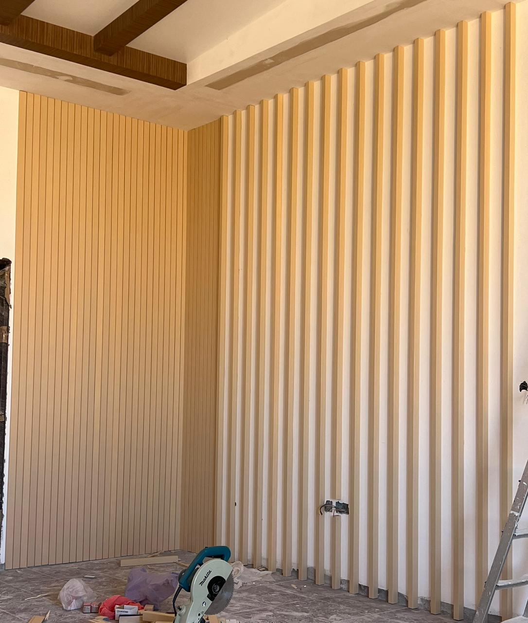 Fluted wood wall panelling in progress